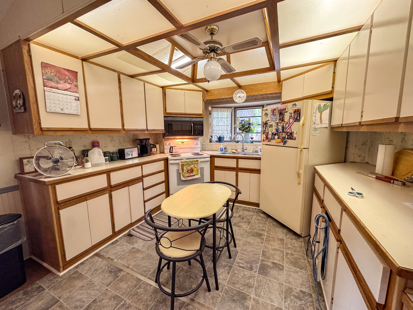 2-24 Woodhaven Sublette, IL 61367 - Photo 10 of 17 a kitchen with a dining table chairs and cabinets