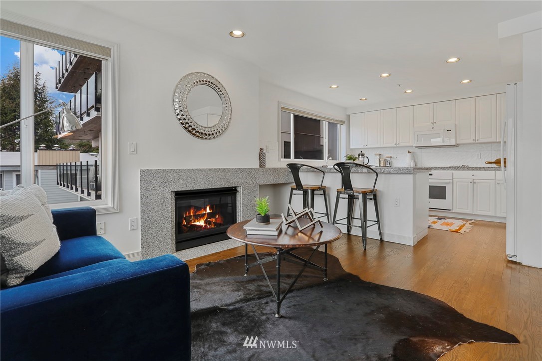 601 West Mercer Place, Unit 201 Seattle, WA 98119 - Photo 11 of 36 a living room with furniture a rug and a fireplace