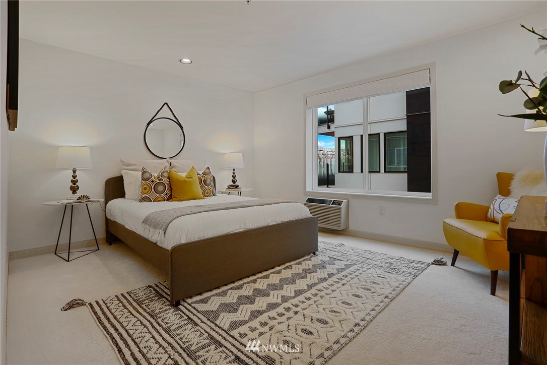 601 West Mercer Place, Unit 201 Seattle, WA 98119 - Photo 19 of 36 a bedroom with a bed a table and chair