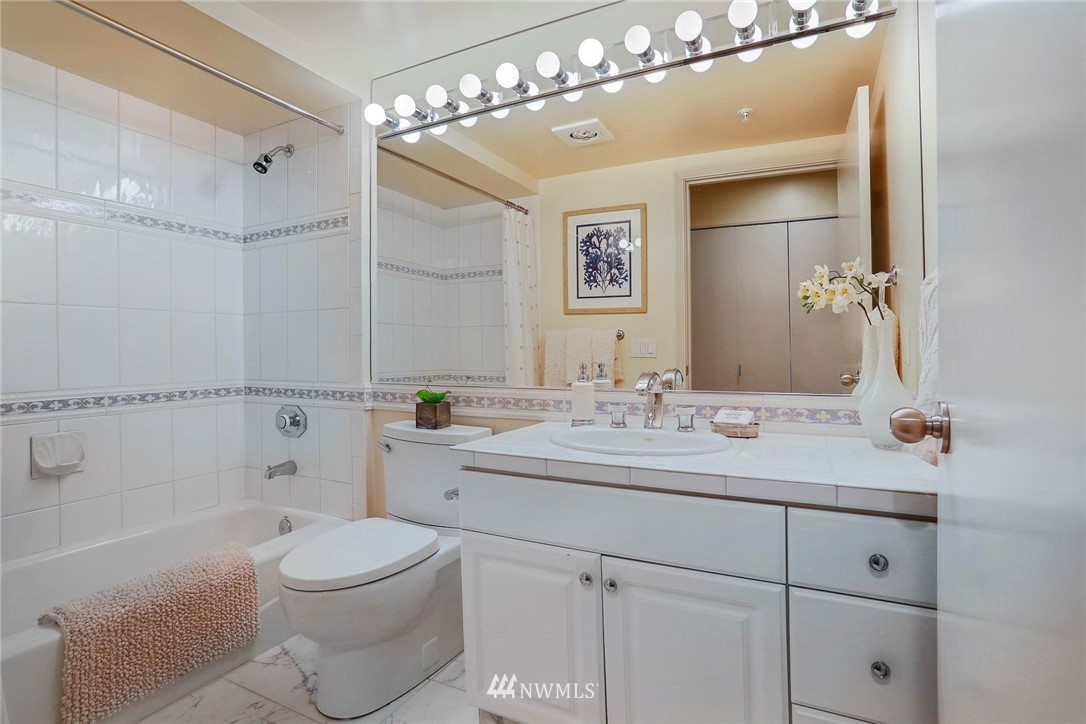 601 West Mercer Place, Unit 201 Seattle, WA 98119 - Photo 26 of 36 a bathroom with a toilet a sink a tub and mirror