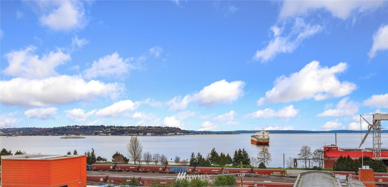 601 West Mercer Place, Unit 201 Seattle, WA 98119 - Photo 29 of 36 a view of a lake with table and chairs