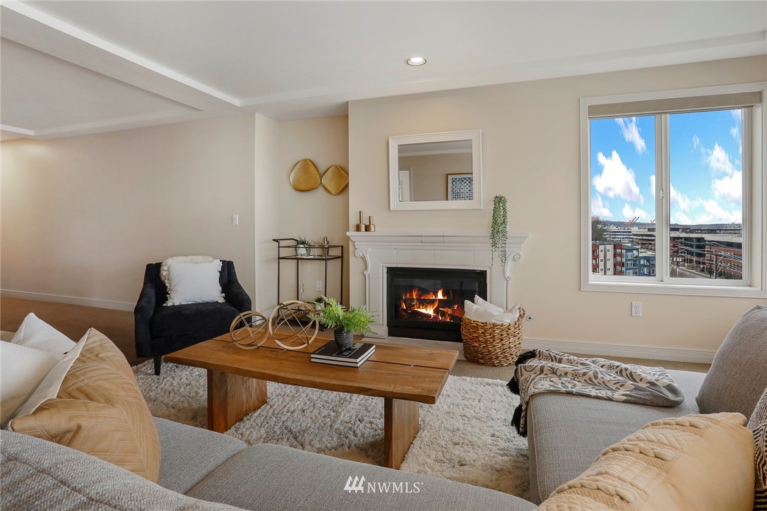 601 West Mercer Place, Unit 201 Seattle, WA 98119 - Photo 6 of 36 a living room with furniture and a fireplace