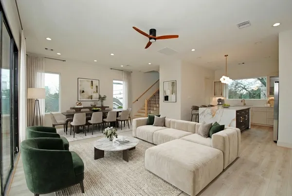 a living room with couches and kitchen view