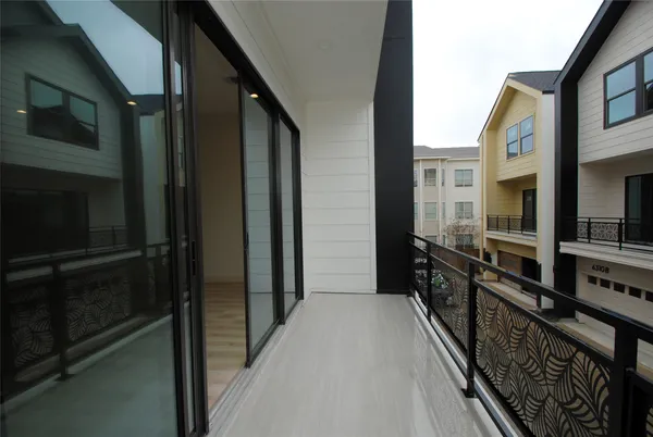 a bedroom with a large bed and a potted plant