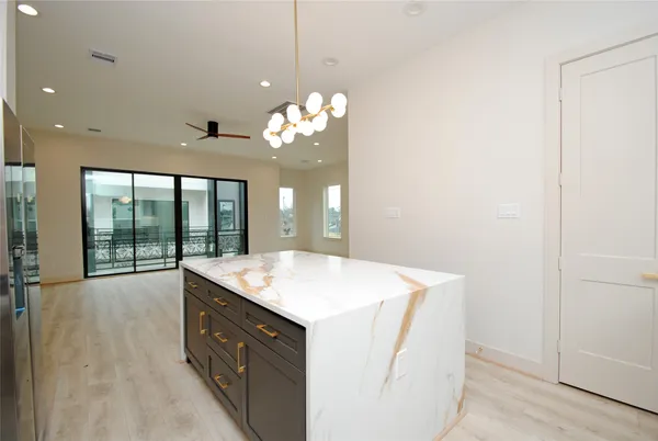 a view of a kitchen with a sink cabinets and entryway