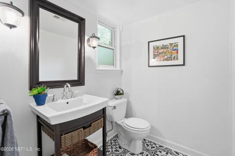 a bathroom with a toilet sink and mirror