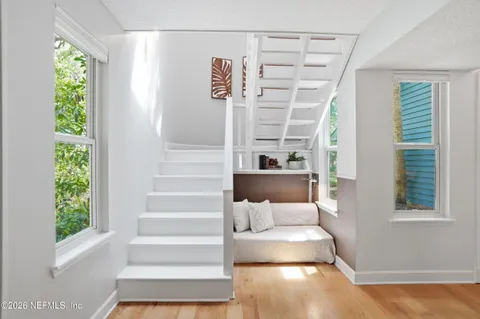 a view of staircase with white walls and a window