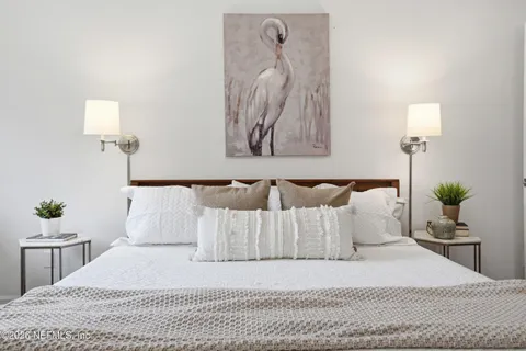 a bedroom with a bed and a lamp