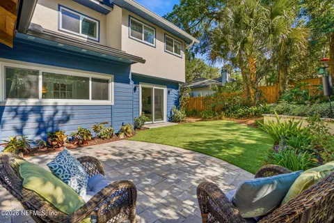 a view of a backyard with plants and outdoor seating