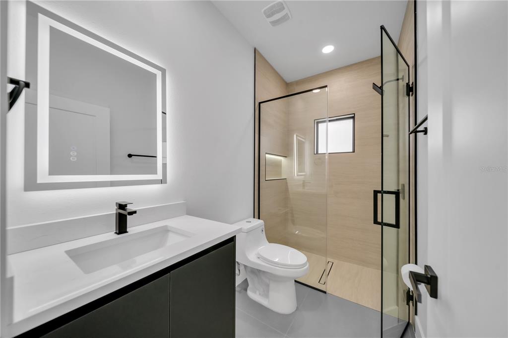 2328 Irondale Road North Port, FL 34287 - Photo 21 of 45 a bathroom with a sink toilet a mirror and shower