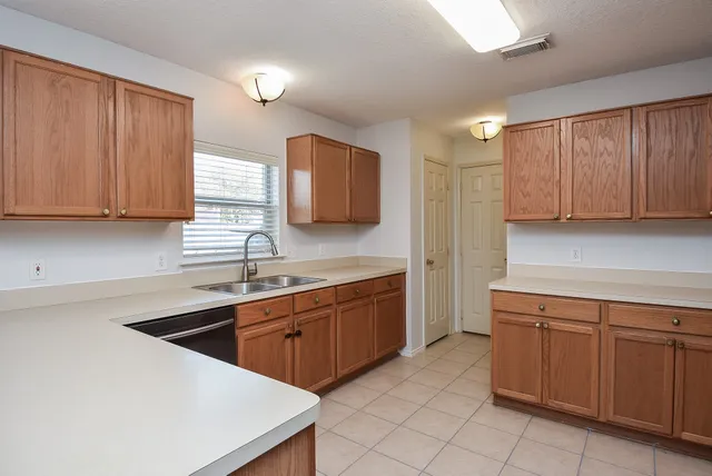 a kitchen with a sink dishwasher a stove and a microwave oven