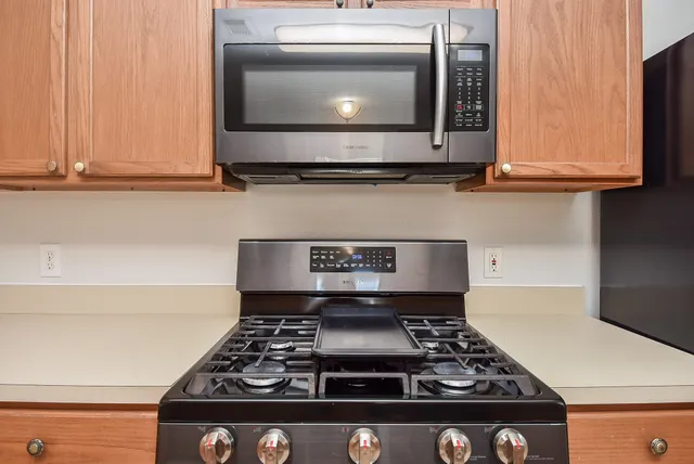 a stove top oven sitting inside of a kitchen