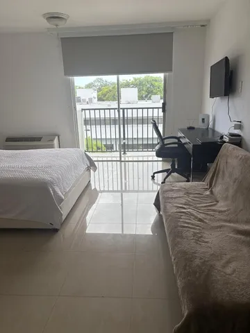 a living room with furniture tv and a window