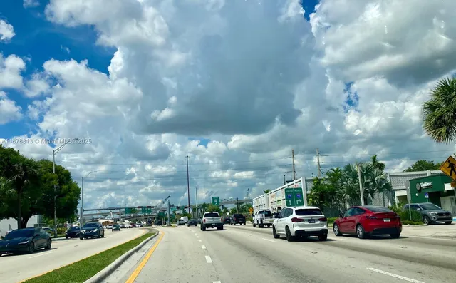 a view of a city street with cars