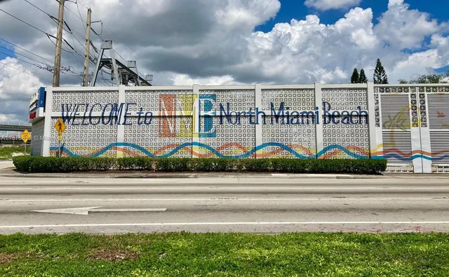 a view of a brick house next to a yard