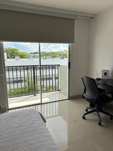 a view of a balcony with chair and wooden floor