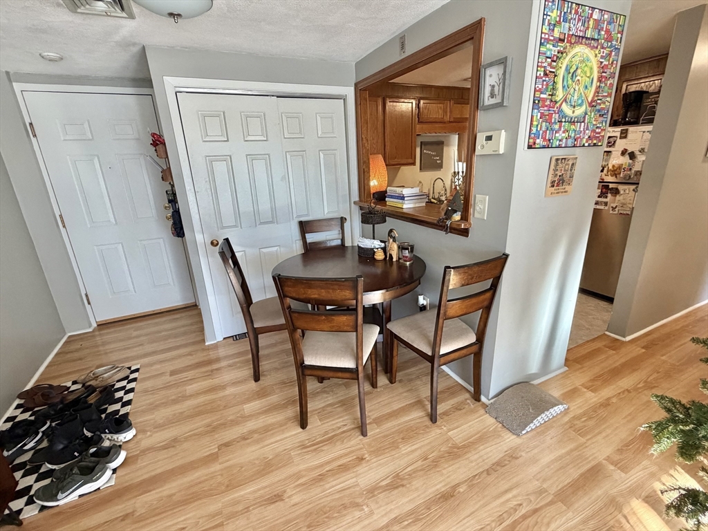 136 Central Street, Unit C 6 Hudson, MA 01749 - Photo 3 of 20 a view of a dining room with furniture and wooden floor