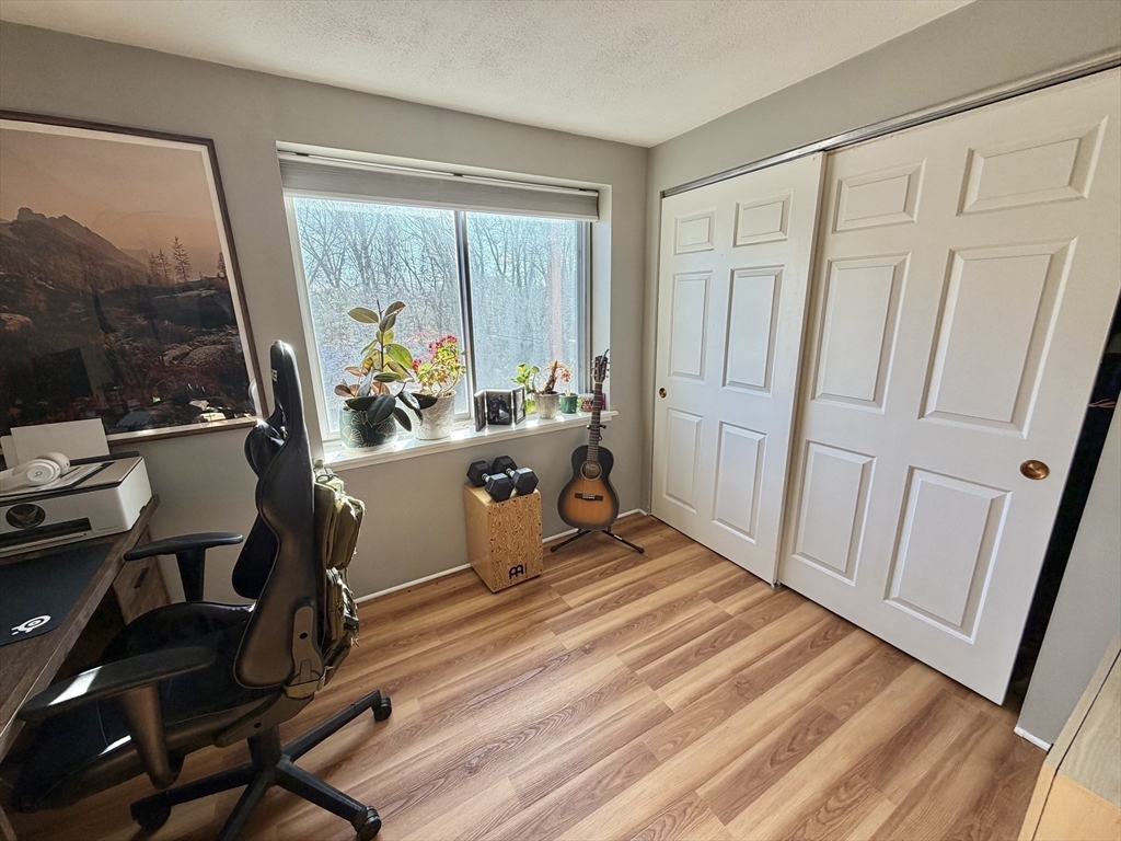 136 Central Street, Unit C 6 Hudson, MA 01749 - Photo 6 of 20 a room with wooden floor and furniture