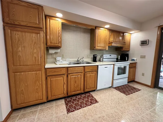a kitchen with a sink a refrigerator and cabinets