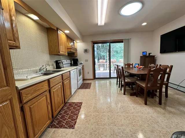 a kitchen with a table chairs sink and microwave
