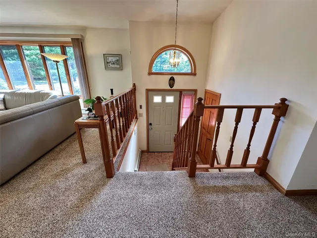 a view of a livingroom with furniture and stairs