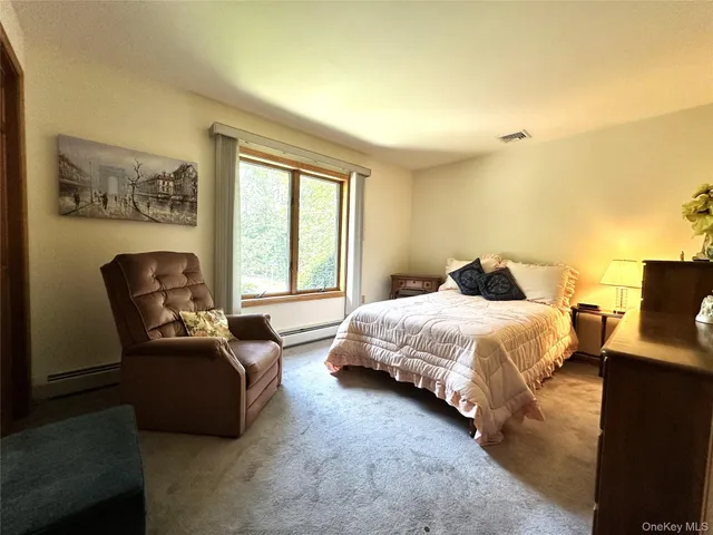 a bedroom with bed and window