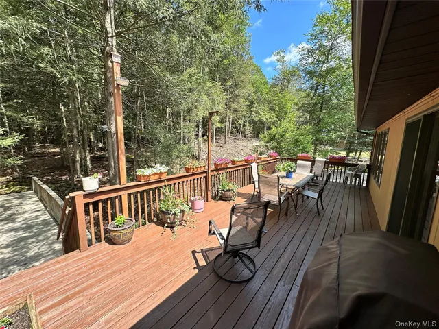 a view of a patio with table and chairs and wooden floor