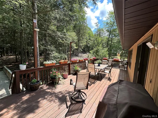 a view of a balcony with wooden floor and fence