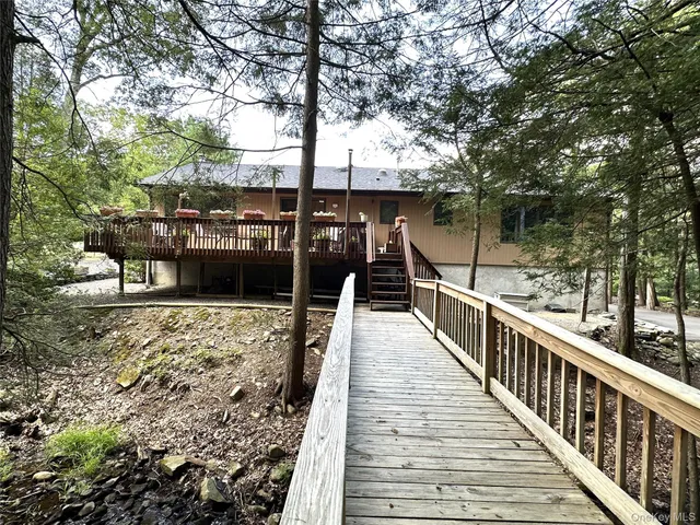 a view of balcony with wooden floor and fence
