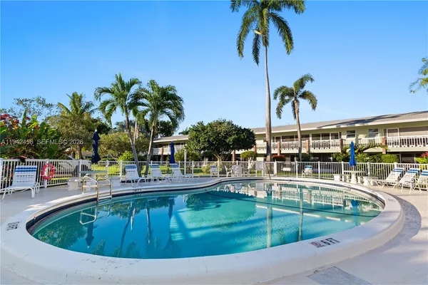 a swimming pool with outdoor seating and yard