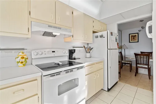 a kitchen with a sink a stove cabinets and counter space