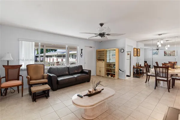 a living room with furniture a table and a flat screen tv