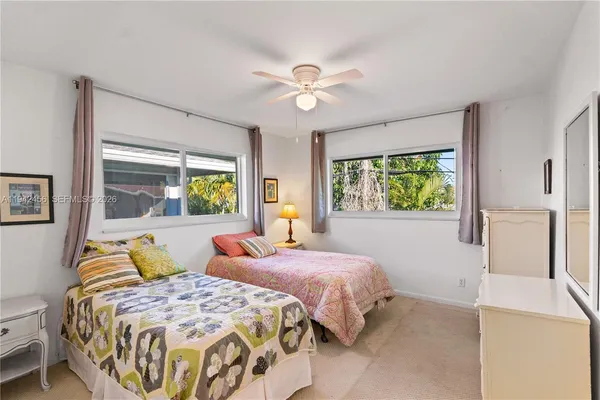 a bedroom with two beds and a chandelier