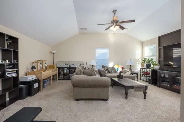 a living room with furniture and a flat screen tv