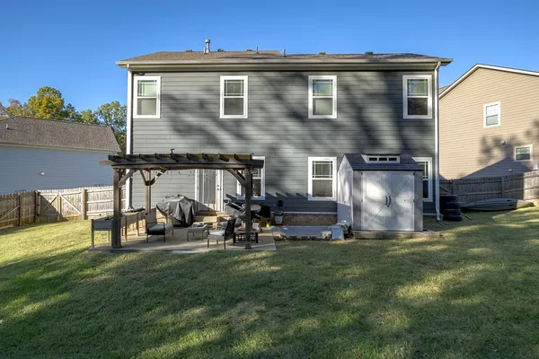 a view of a house with a yard and sitting area