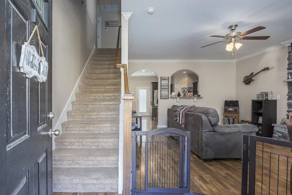 a view of a livingroom with furniture and staircase
