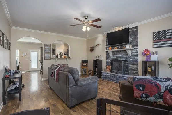a living room with fireplace furniture and a flat screen tv