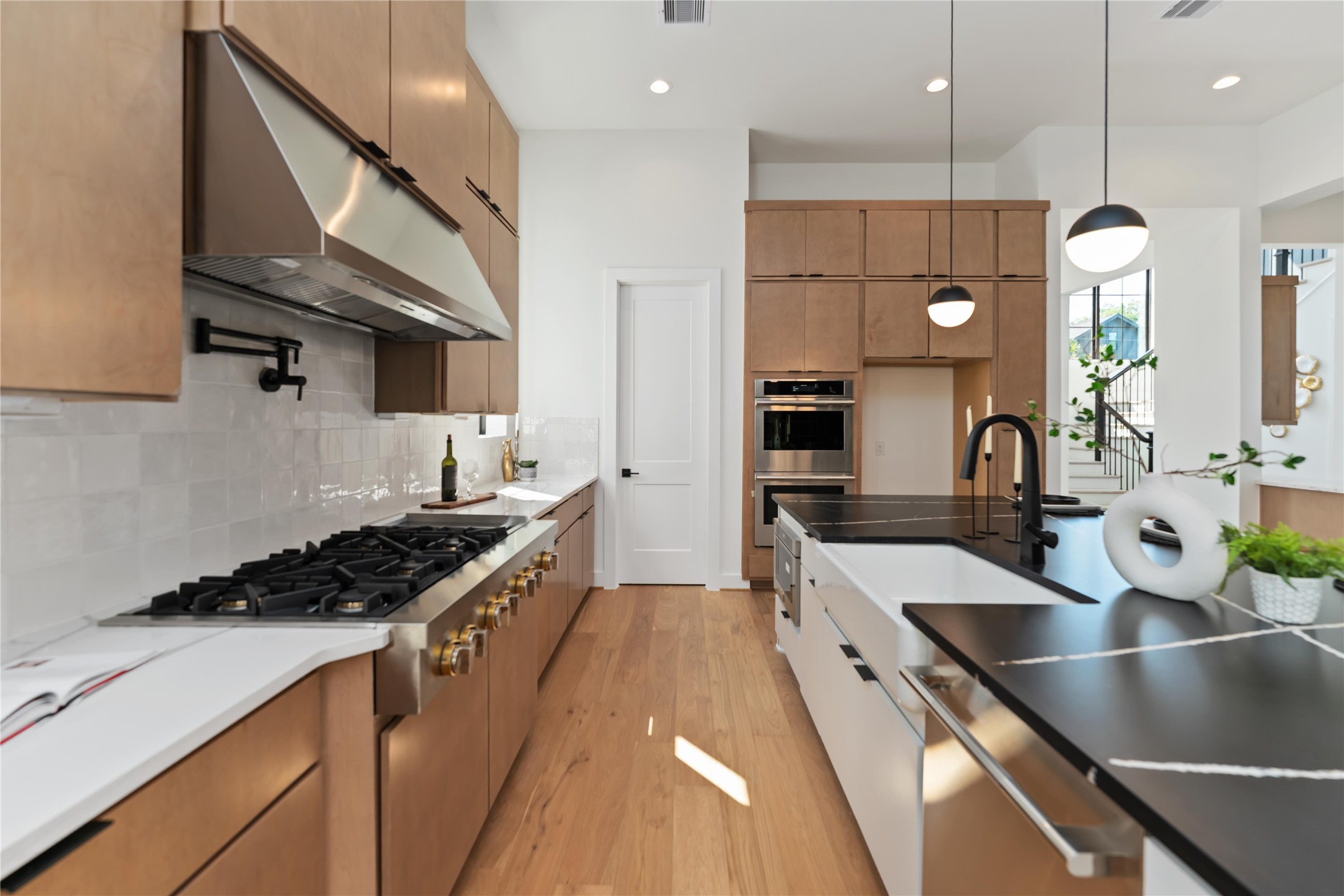 615 Wendel Street Houston, TX 77009 - Photo 4 of 21 a kitchen with stainless steel appliances granite countertop a sink a stove and a wooden floors