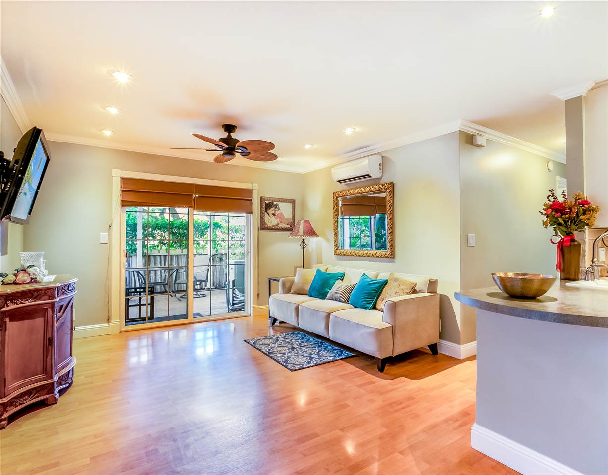 140 Uwapo Road, Unit 6101 Kihei, HI 96753 - Photo 1 of 30 a living room with furniture large window and flat screen tv