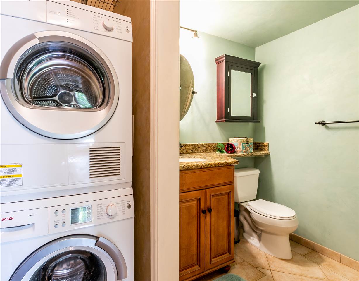 140 Uwapo Road, Unit 6101 Kihei, HI 96753 - Photo 16 of 30 a bathroom with a toilet sink and mirror