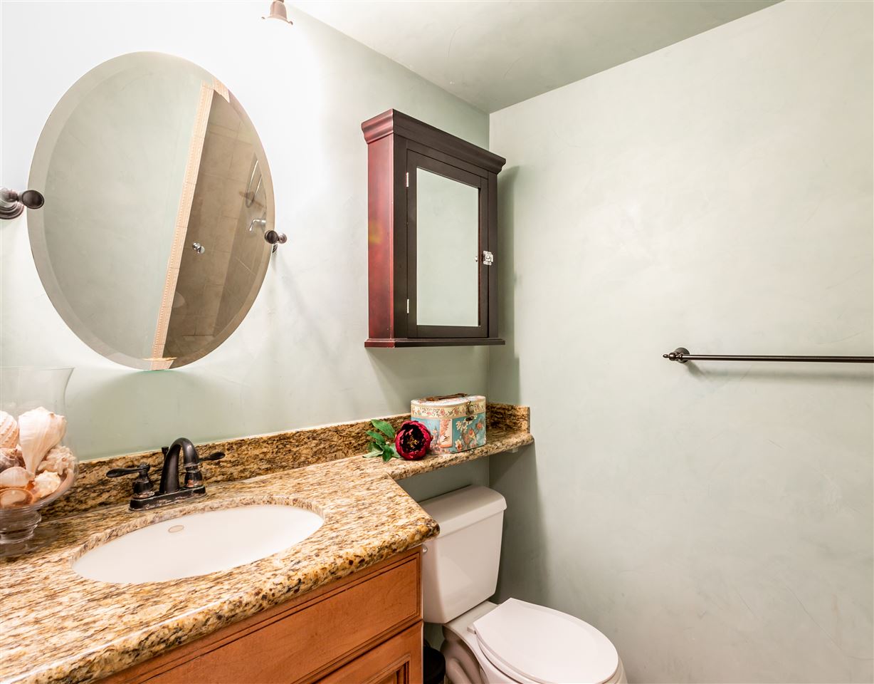 140 Uwapo Road, Unit 6101 Kihei, HI 96753 - Photo 17 of 30 a bathroom with a granite countertop sink mirror and toilet