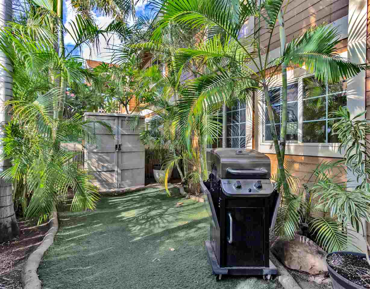 140 Uwapo Road, Unit 6101 Kihei, HI 96753 - Photo 27 of 30 a view of a chair and table in backyard