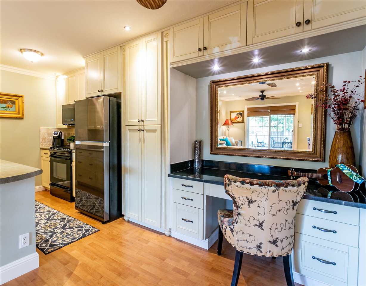 140 Uwapo Road, Unit 6101 Kihei, HI 96753 - Photo 6 of 30 a kitchen with stainless steel appliances kitchen island granite countertop a refrigerator and a stove top oven