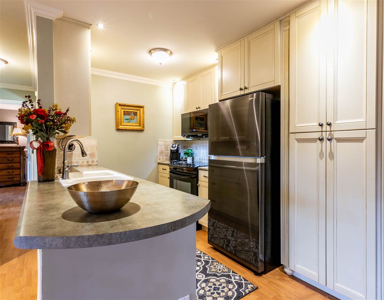 140 Uwapo Road, Unit 6101 Kihei, HI 96753 - Photo 7 of 30 a kitchen with a refrigerator and a sink
