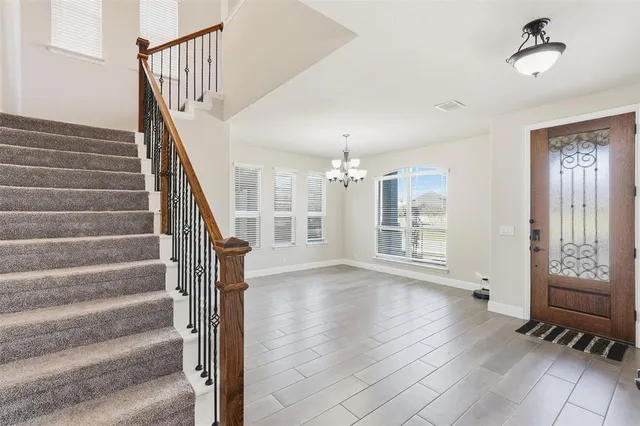 a view of an entryway with wooden floor and a front door