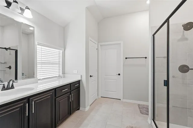 a bathroom with a double vanity sink and mirror