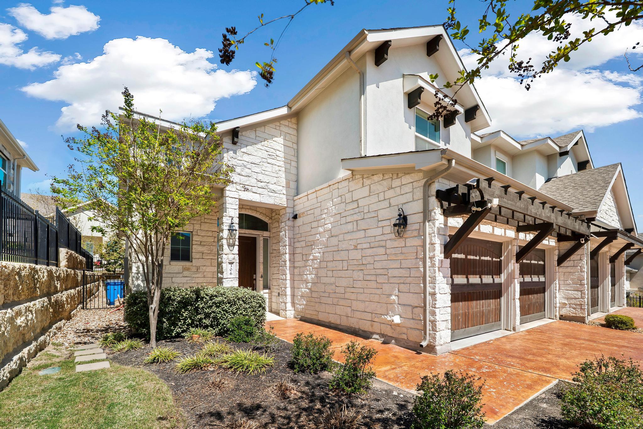306 Cartwheel Bend, Unit 130 Austin, TX 78738 - Photo 18 of 40 a view of a house with a yard