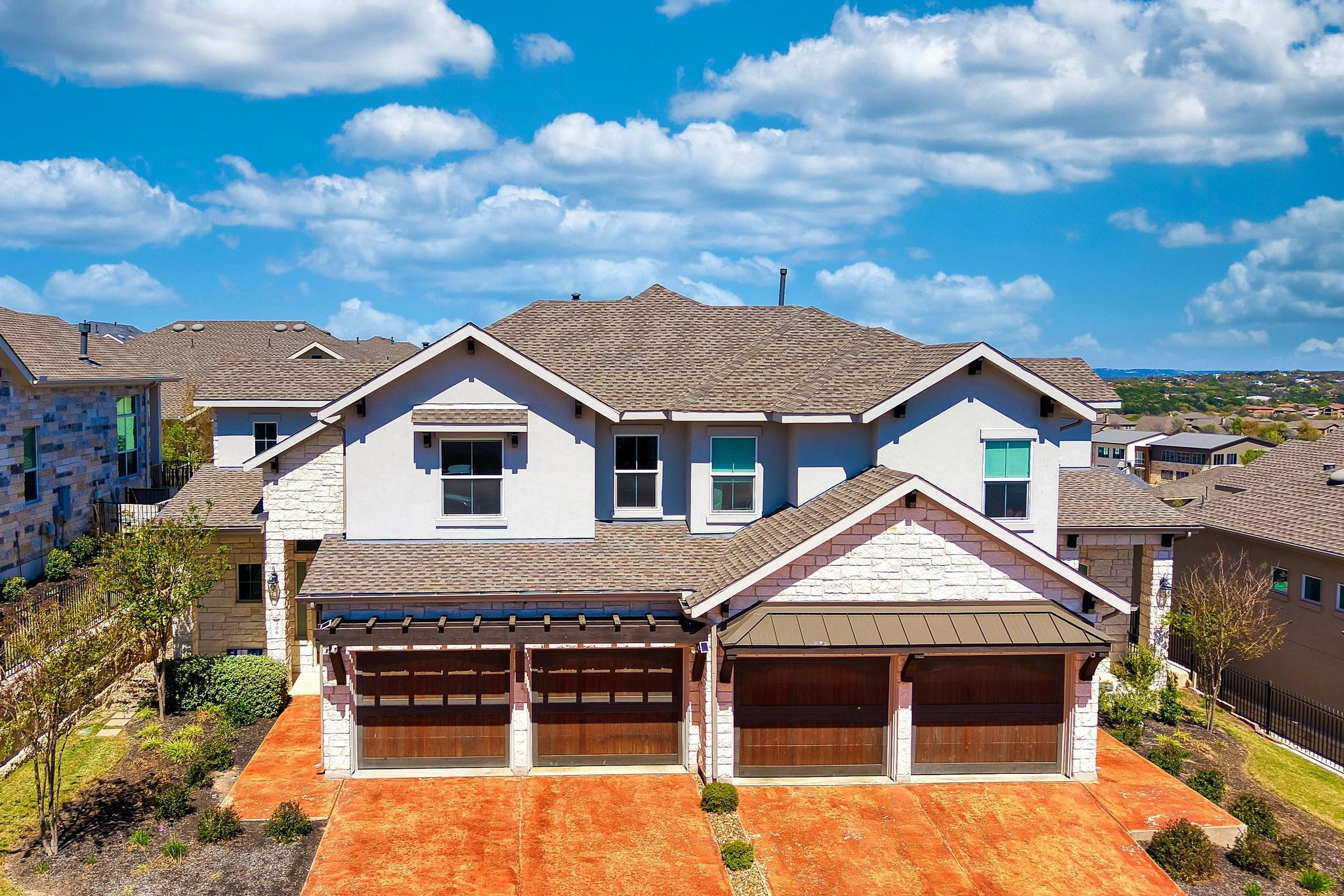 306 Cartwheel Bend, Unit 130 Austin, TX 78738 - Photo 2 of 40 a front view of a house with a yard