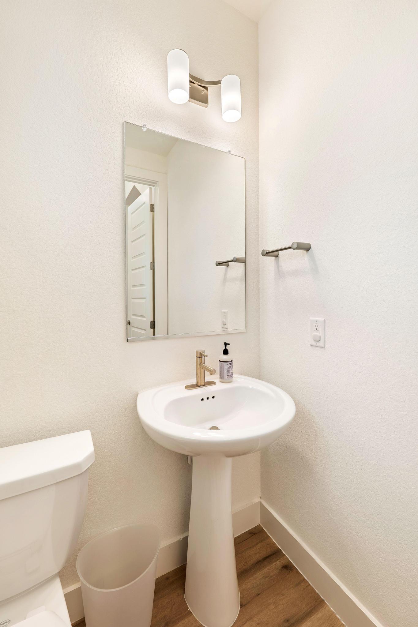 306 Cartwheel Bend, Unit 130 Austin, TX 78738 - Photo 21 of 40 a bathroom with a sink toilet and mirror