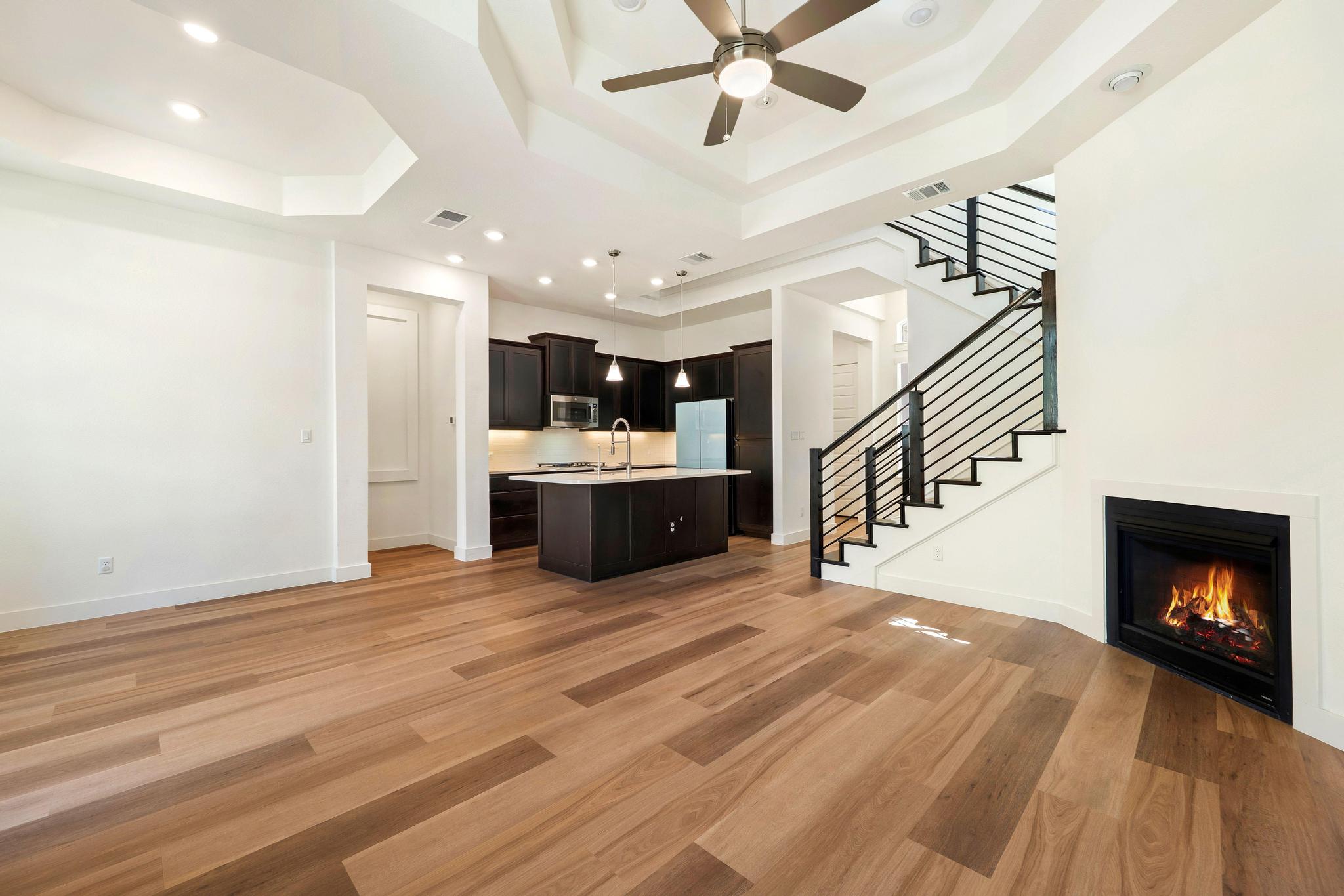 306 Cartwheel Bend, Unit 130 Austin, TX 78738 - Photo 24 of 40 a view of a kitchen with a sink and a fireplace